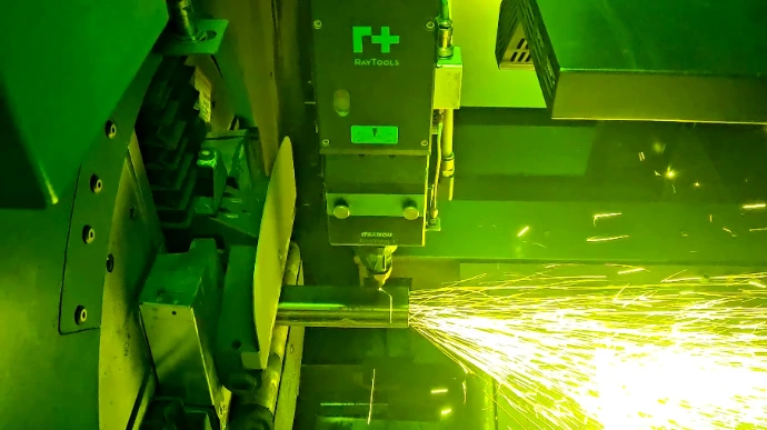 A square tube being cut on a tube laser.