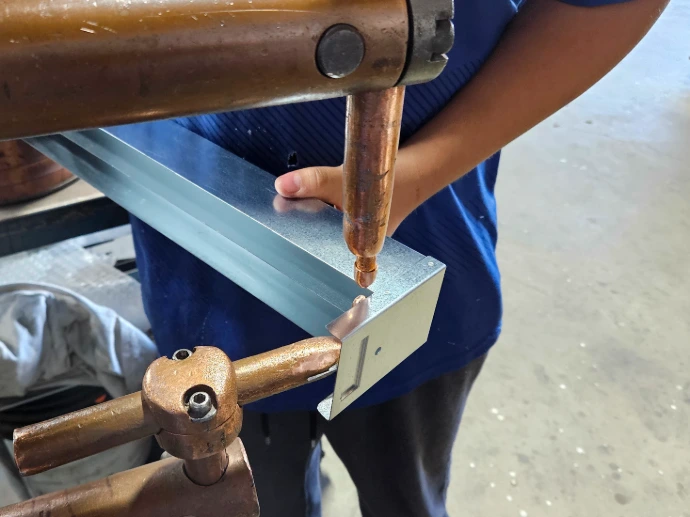 A part being welded with a resistance spot welder
