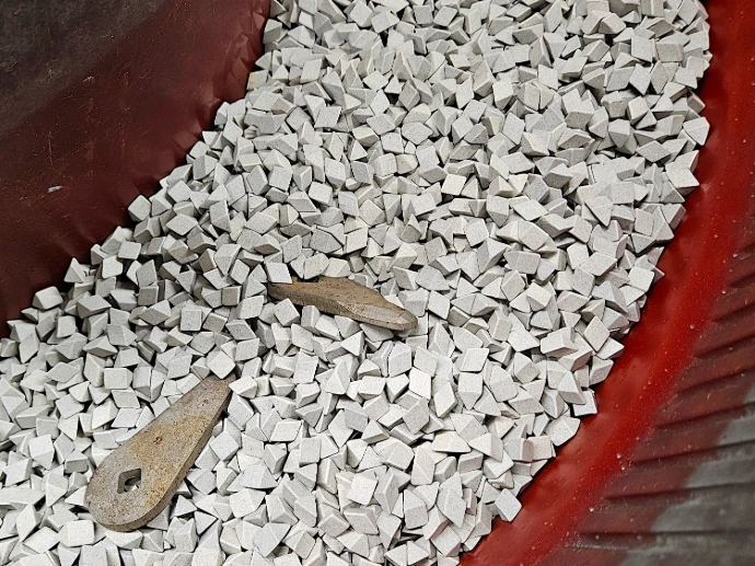 Parts being deburred via vibratory deburring